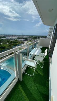 Beachfront · Private Beach Two Bedroom with Balcony by The Bali Corner at Azure North , POOL and BEACH VIEW - unit with Bathtub - Housity