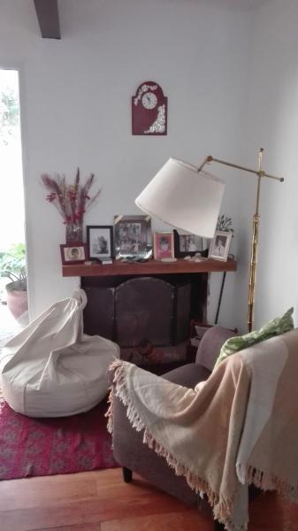 sala de estar con cama y lámpara en La casa de Silvia en Puerto Madryn