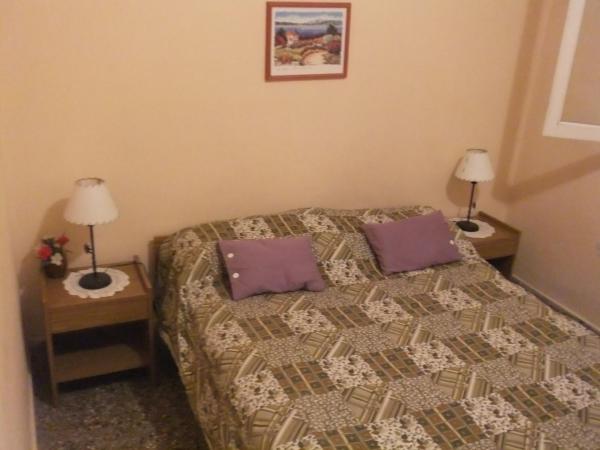 1 dormitorio con 1 cama con 2 almohadas en Comodo Chalet en Gesell en Villa Gesell