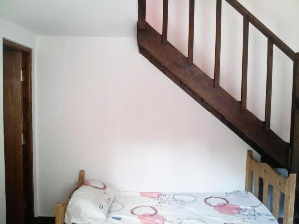 un dormitorio con una cama y una escalera en Sol y Sombra en Villa Gesell