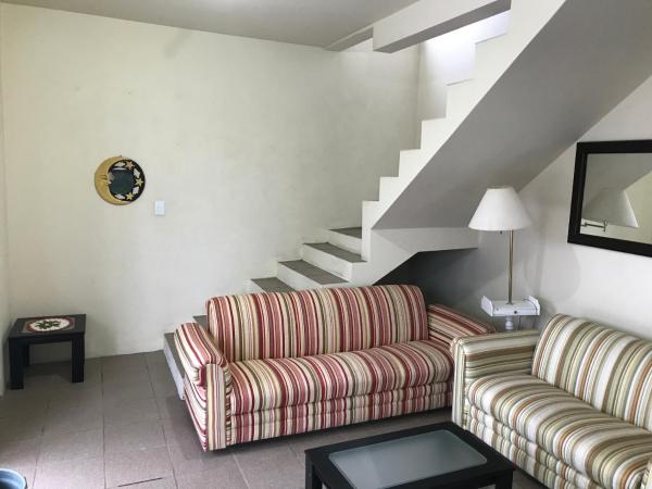 a living room with two couches and a staircase at Casa 4 Quartos Praia dos Ingleses in Florianópolis