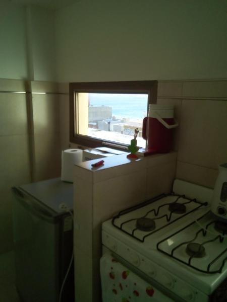 cocina pequeña con fogones y ventana en Monoambiente Madryn en Puerto Madryn