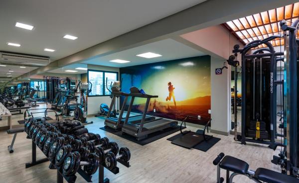 a gym with rows of tread machines and a large mural at Blue Tree Premium Florianópolis in Florianópolis