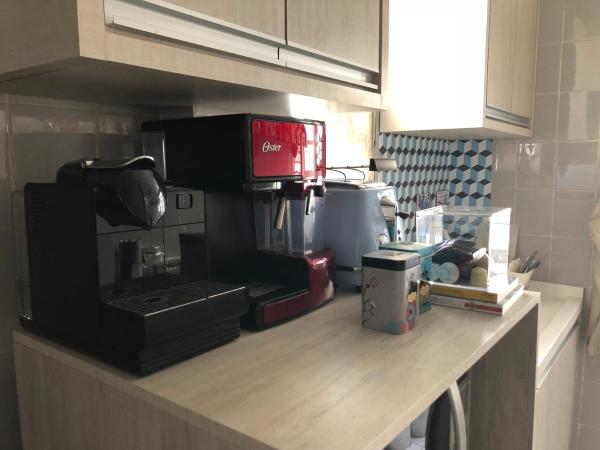 a kitchen counter top with a coffee maker on it at Apto continente Florianópolis in Florianópolis