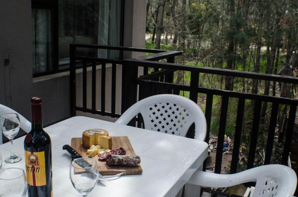 una mesa blanca con una botella de vino y copas de vino en Poble Yaganes en Mar de las Pampas