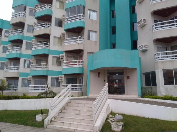 an apartment building with stairs in front of it at Estrela do Mar in Florianópolis