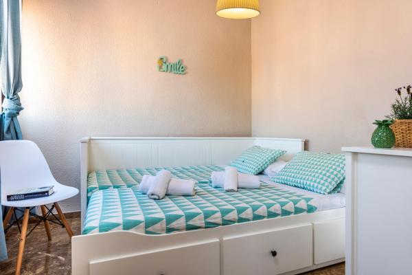 1 dormitorio con 1 cama con almohadas azules y blancas en HSH Suites República, en Sevilla