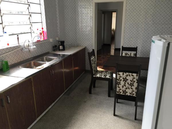 a kitchen with a sink and a table and chairs at AP na Rua das Flores in Curitiba