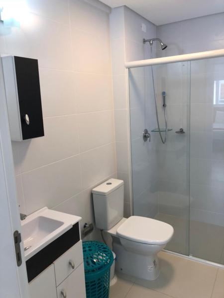 a bathroom with a shower and a toilet and a sink at 210 B Espelho das Aguas in Florianópolis