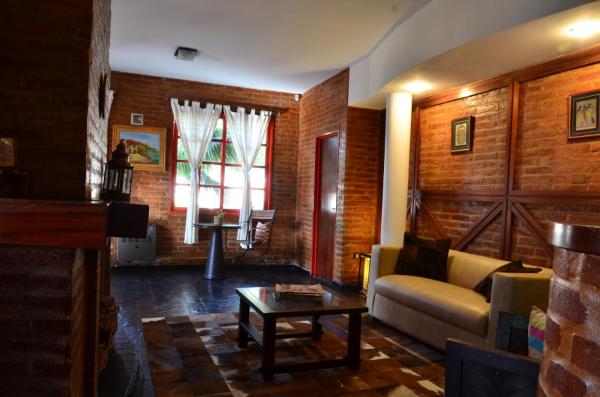sala de estar con sofá y mesa en Posada Alpenrose Neu en Villa Carlos Paz