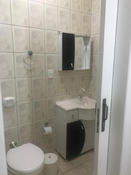 a small bathroom with a toilet and a sink at Apto Rua da Praia in Florianópolis