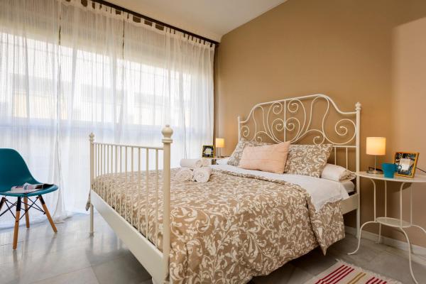 1 dormitorio con cama blanca y ventana a HSH Suites Magdalena, en Sevilla