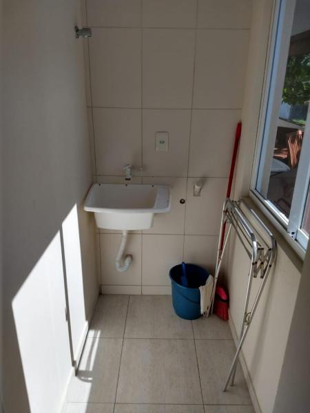 baño pequeño con lavabo y ventana en Residencial Melfi 3 Ap.5 Lateral, en Bombinhas