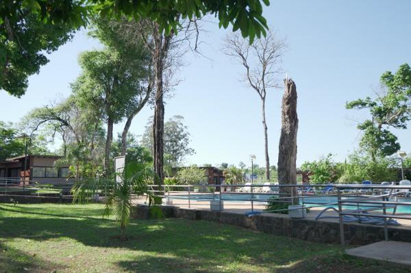 un parque con árboles y una piscina en Gran Hotel Tourbillon & Lodge en Puerto Iguazú