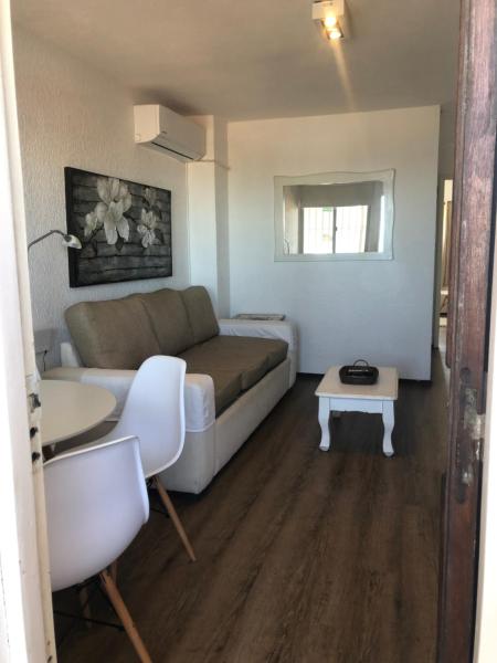 sala de estar con sofá y mesa en Apartamento 4 Mares - El Faro, en Punta del Este
