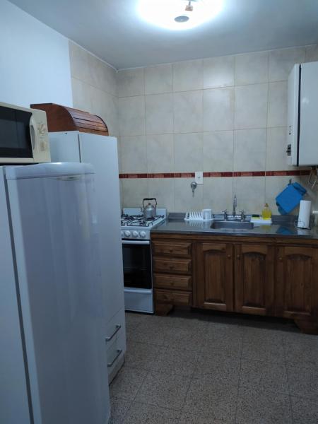a kitchen with a white refrigerator and a sink at Departamento céntrico en Santa Fe capital in Santa Fe