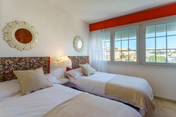 Cama o camas de una habitación en MálagaSuite Carihuela Seaview