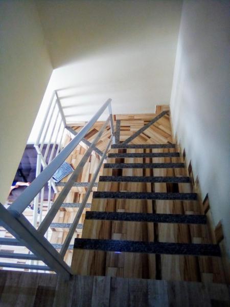 a staircase in a building with wooden floors and a stair case at Casa no rio vermelho in Florianópolis