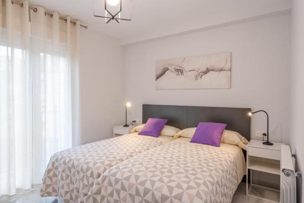 Cama o camas de una habitación en Congresos Granada Apartment by A3Rentals