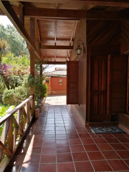 a porch of a house with a wooden door at La Manuela in Piriápolis