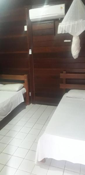 Cama o camas de una habitación en CHALES AABB SALVADOR(BA)