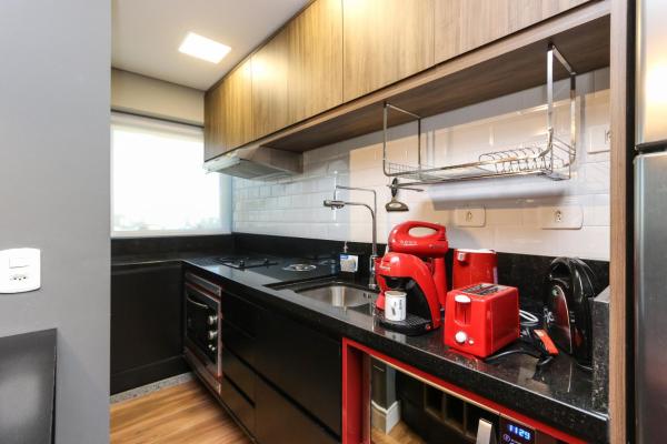 a kitchen with a red appliance on a counter at Studio Berlin - Central - 7th012 in Curitiba