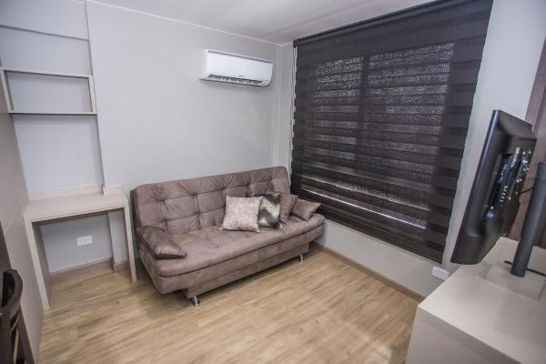 a living room with a couch and a television at Studio com Cama e Sofá-Cama de Casal - ALL2011 in Curitiba