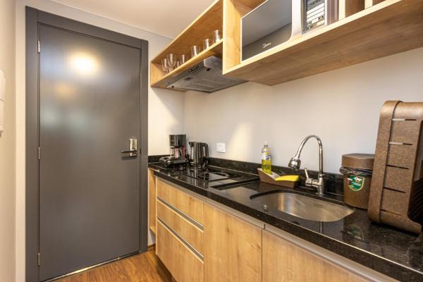 a kitchen with a sink and a counter top at Studio Serra do Mar - Central - AYN029 in Curitiba