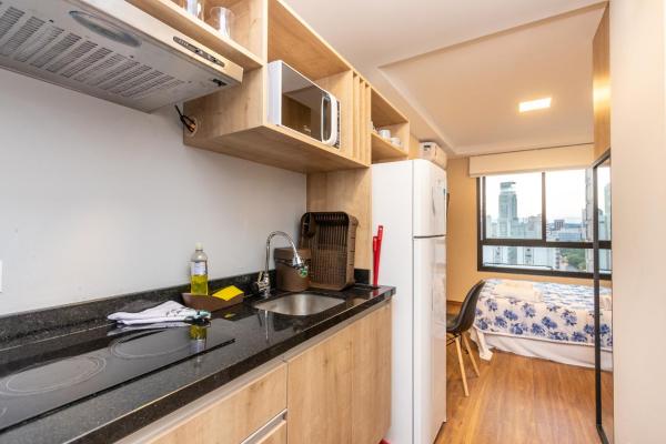 a kitchen with a sink and a refrigerator at Studio Serra do Mar - Central - AYN029 in Curitiba