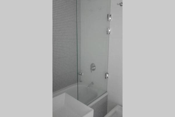 y baño con ducha, lavabo y bañera. en Estudio Dos Orillas, en Colonia del Sacramento