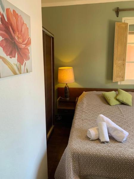 a bedroom with a bed with two pillows and a lamp at Hosteria Uruguay in Piriápolis