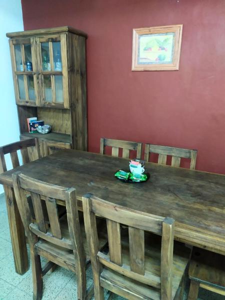 a wooden table and chairs in a room at Departamento céntrico en Santa Fe capital in Santa Fe