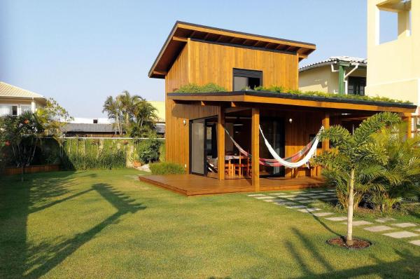 a house with a hammock in a yard at Exclusive EcoHouse! Privacy 100 m Praia Campeche in Florianópolis