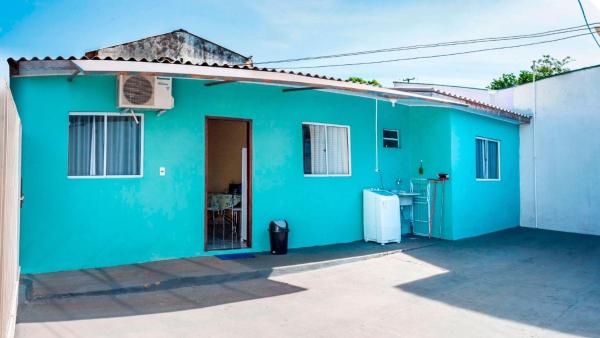 una casa azul con una nevera frente a ella en Ambiente familiar e confortável, en Foz do Iguaçu