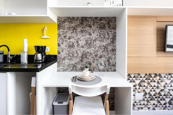 a small kitchen with a white table and chairs at Welcome CWB - AYN037 in Curitiba