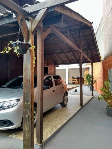 a car garage with a car parked underneath it at Casa no Campeche com Piscina in Florianópolis