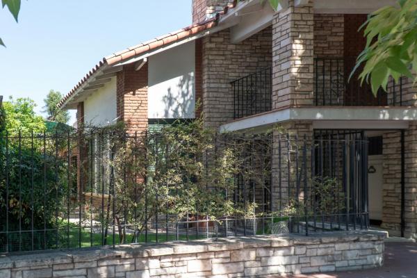 una casa de ladrillo con una puerta de hierro forjado negro en Habitación en La Casa de Mis Padres en Mendoza