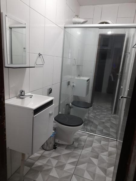 a bathroom with a toilet and a sink and a shower at Casa na praia dos ingleses in Florianópolis