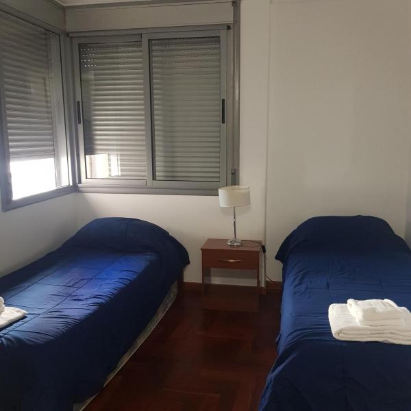 Una cama o camas en una habitación de Edificio Pampa - Departamento Nueva Córdoba