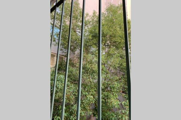 una ventana abierta con árboles en el fondo en Best location in Caballito, Buenos Aires, 80 M2 en Buenos Aires