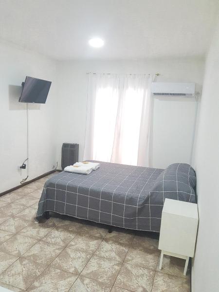 a bedroom with a bed in a room with a window at Departamento con COCHERA - Santa Fe in Santa Fe