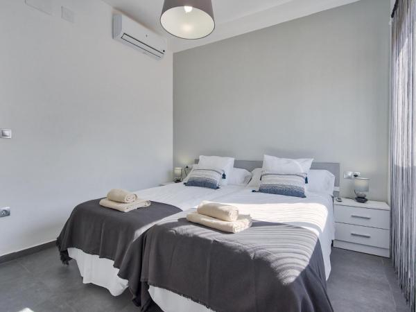 Cama o camas de una habitación en Sur Suites El Carmen
