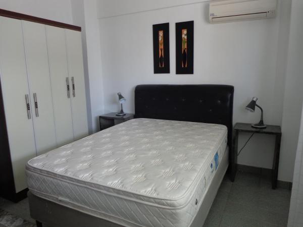 Cama o camas de una habitación en PRAIA DE 4 ILHAS Apartamento De 1 Quarto a 60M Praia Com Vista
