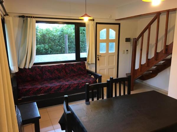 sala de estar con sofá rojo y mesa en Los Paraisos en Villa Gesell