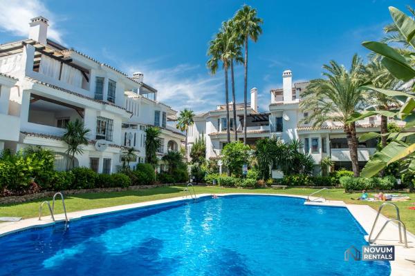 una piscina frente a un gran edificio en Spacious Penthouse in Los Naranjos - Up to 6 GUESTS!, en Marbella