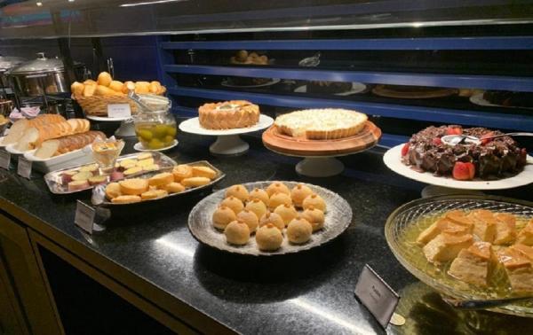 a buffet with many different types of cakes and pastries at Blue Tree Premium Florianópolis in Florianópolis