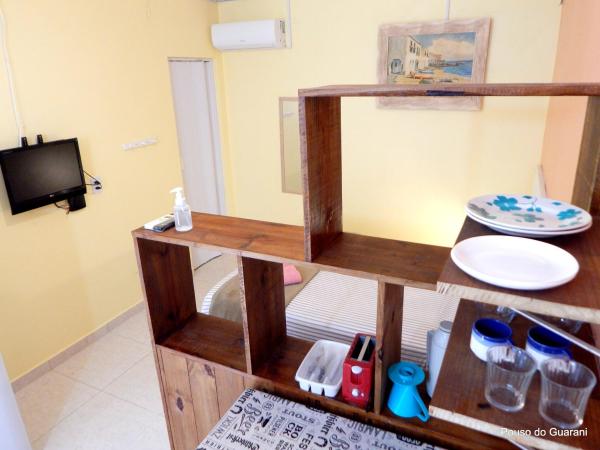 a wooden shelf with plates and dishes in a room at Estúdio7 com cozinha, garagem, ar, 250 m do mar in Florianópolis