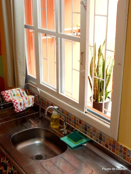 a kitchen sink with a window above it at Estúdio7 com cozinha, garagem, ar, 250 m do mar in Florianópolis