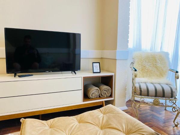 una sala de estar con Tv LED en una cómoda en MRG - Charmoso 2D na Rua Coberta, en Gramado