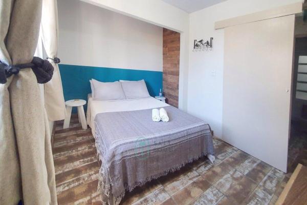 A bed or beds in a room at 10 passos da areia Barra da Lagoa